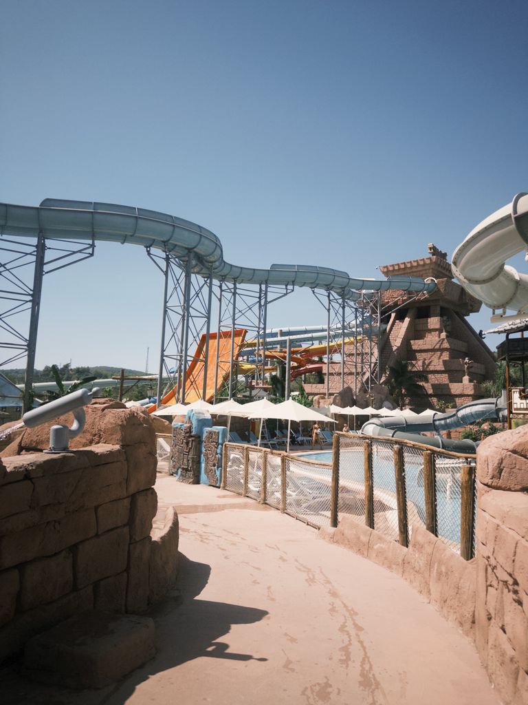 Enjoy a sunny day at a busy water park with adventurous slides and structures.